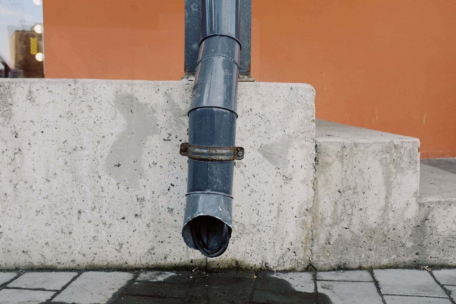 Downspout dripping by a wall