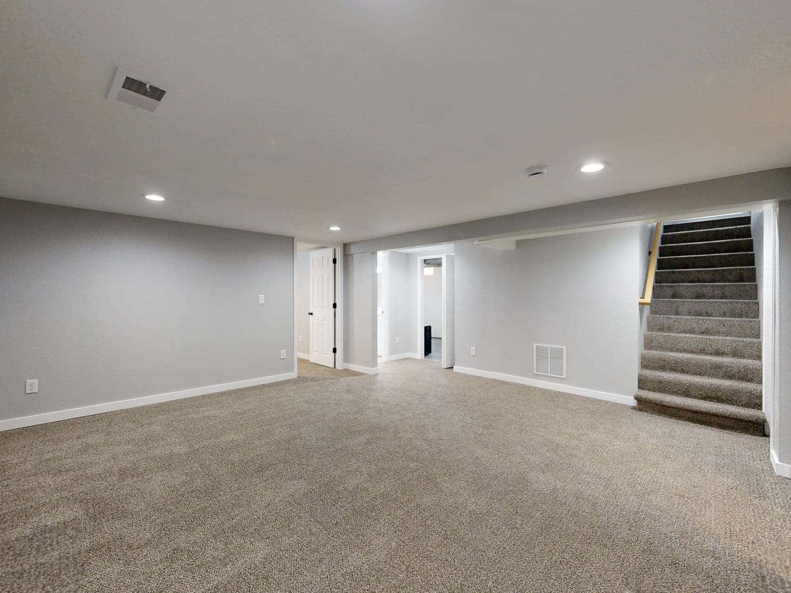 Finished basement with carpet and stairs