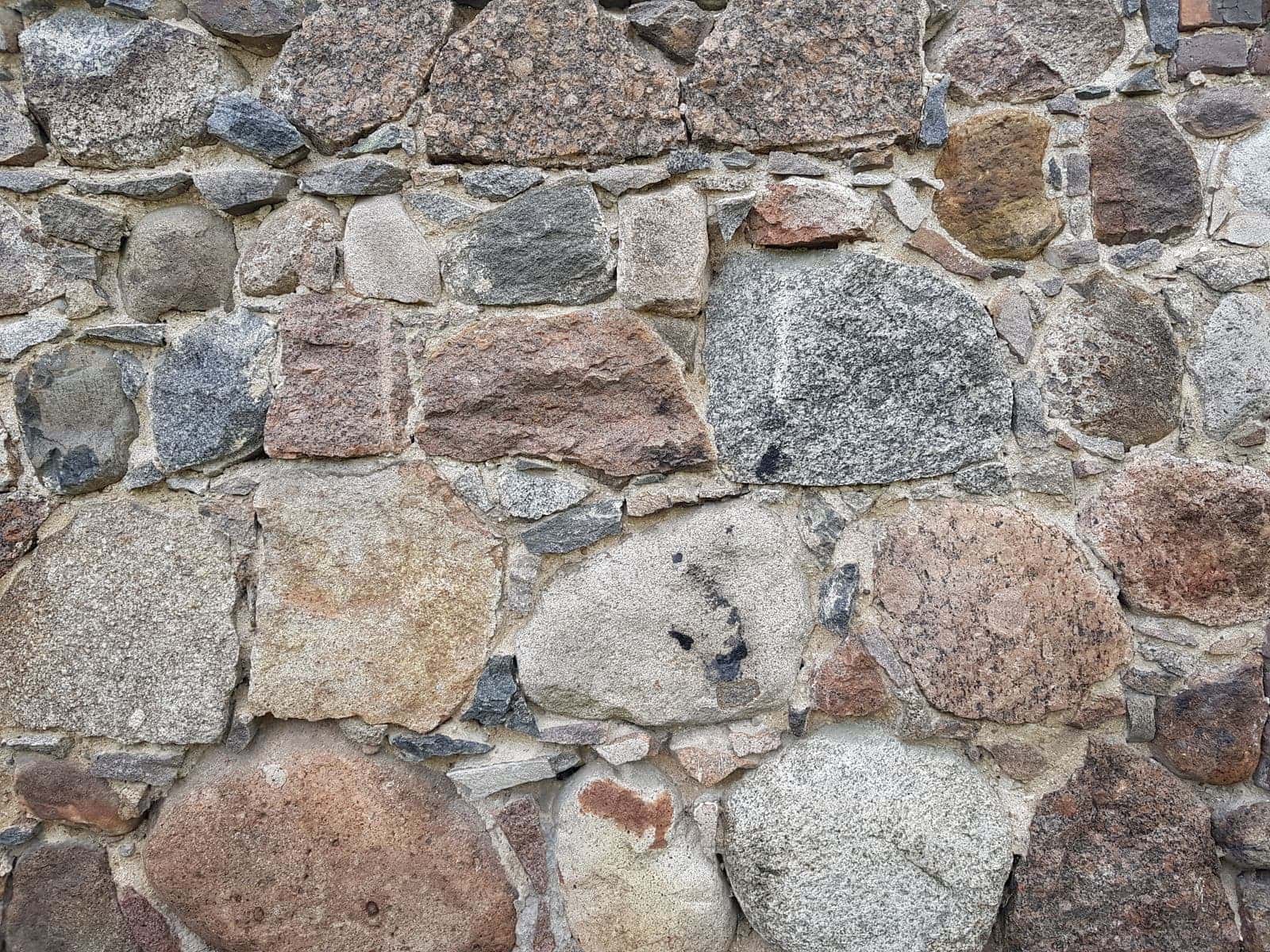 Stone foundation wall exposed outside a house